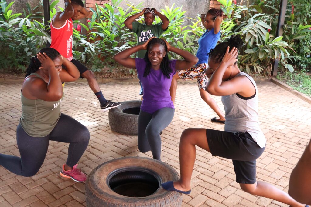 Strength and focus in motion. It’s all about core strength and balance as the team powers through lunges using tire props to challenge their endurance
